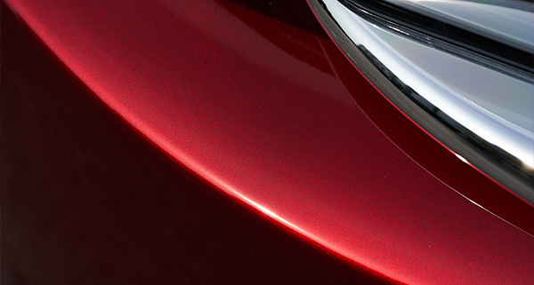 close up of a metal flake finish on a red car